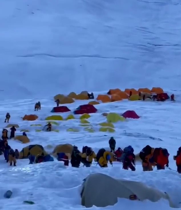 Images show the line of climbers waiting to scale the mountain serpents all the way to base camp