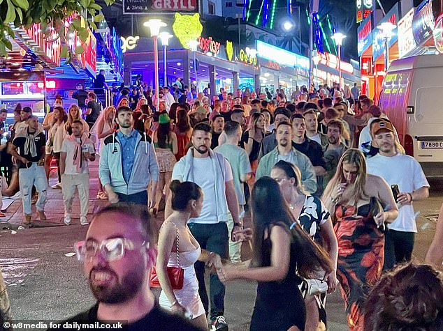 Young men chatted as they flitted between bars in the resort's infamous strip