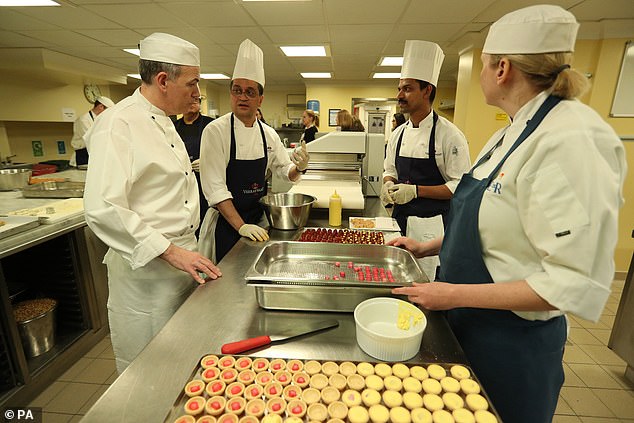 Buckingham Palace Chef Mark Flanagan (left) is seen with other kitchen staff as they prepare for a reception to mark the launch of the UK-India Year of Culture, 2017