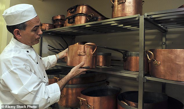 Buckingham Palace chef Mark Flanagan shows off his array of copper pans in the kitchen