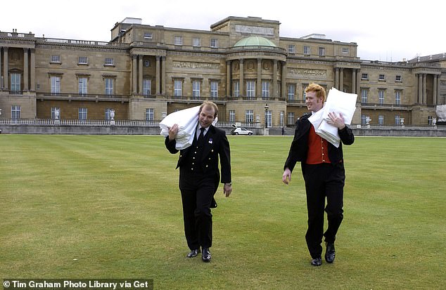 Palace staff carry tablecloths to the royal tea tent in the gardens of Buckingham Palace, 2001