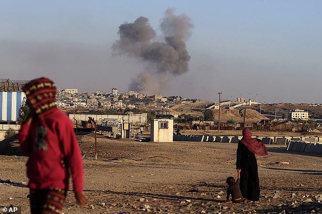Smoke rises after an Israeli airstrike on buildings near the separation wall between Egypt and Rafah on May 7