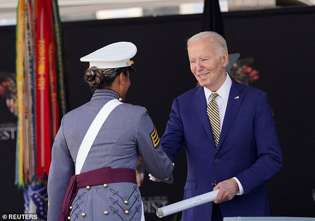 Biden presents a diploma to a graduating cadet during the U.S. Military Academy commencement
