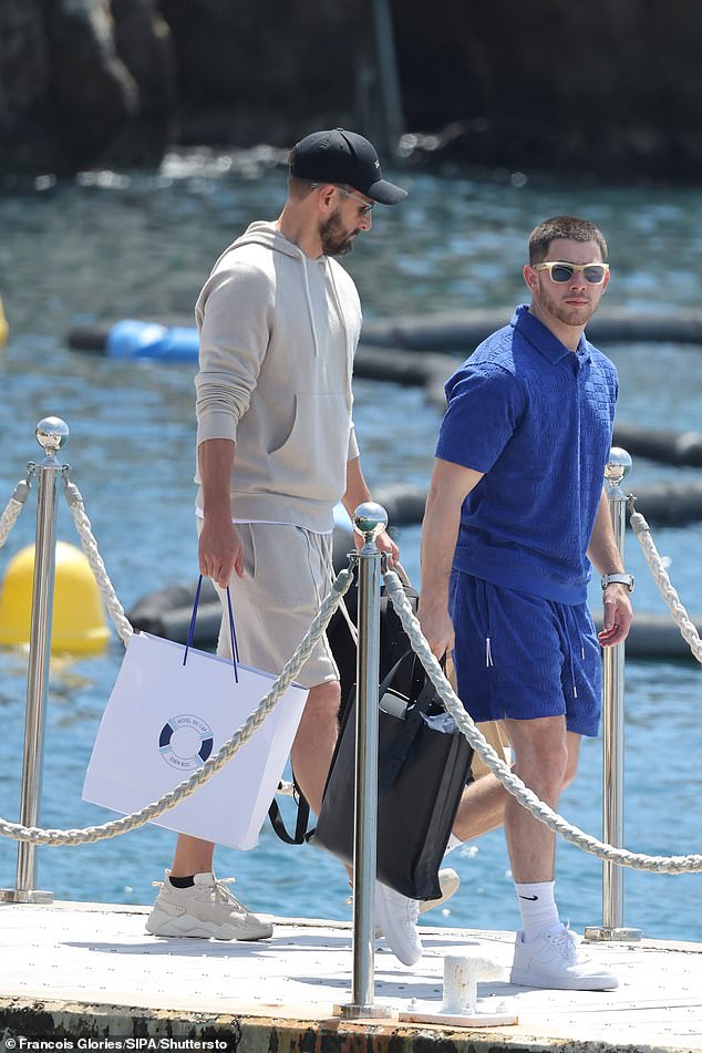 Nick, 31, cuts a casual figure in an electric blue co-ord with a polo T-shirt and matching swim trunks, finished with a pair of sunglasses