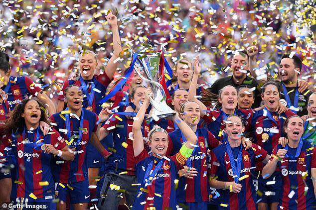 Full-time scenes of cheering broke out as Putellas (centre) lifted the Champions League trophy into the air