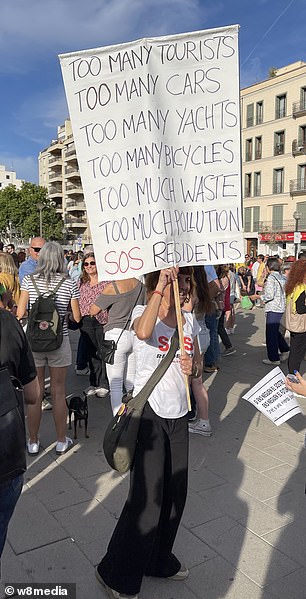 Locals held up anti-tourist signs
