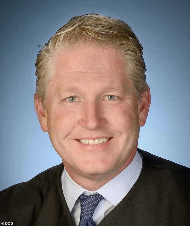 Judge Carl Nichols (pictured) is reviewing the documents privately and is expected to rule 'within weeks' on whether they should be made public
