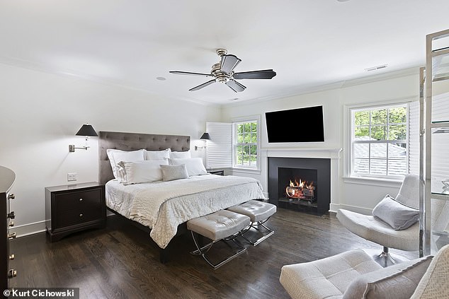 The primary suite features a gas fireplace, walk-in closet and jetted tub