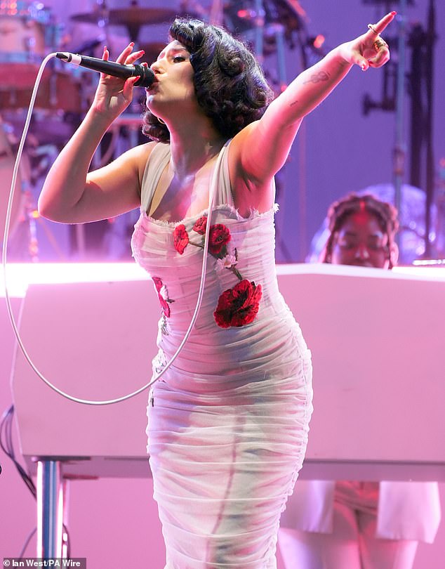 The six-time BRIT Award winner sang her heart out in the strapless white dress adorned with red flowers after taking to the stage on the second day of the event