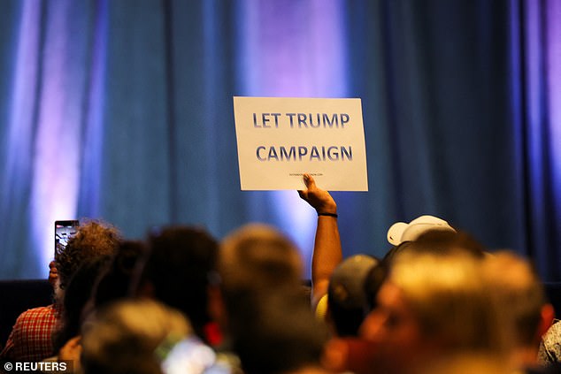 A supporter of former President Donald Trump held up a sign reading 