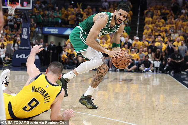 Celtics forward Jayson Tatum (0) controls the ball against Indiana Pacers guard TJ McConnell