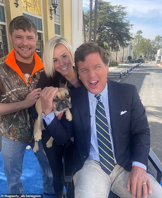 Mitchell and his wife pictured with former Fox News host Tucker Carlson