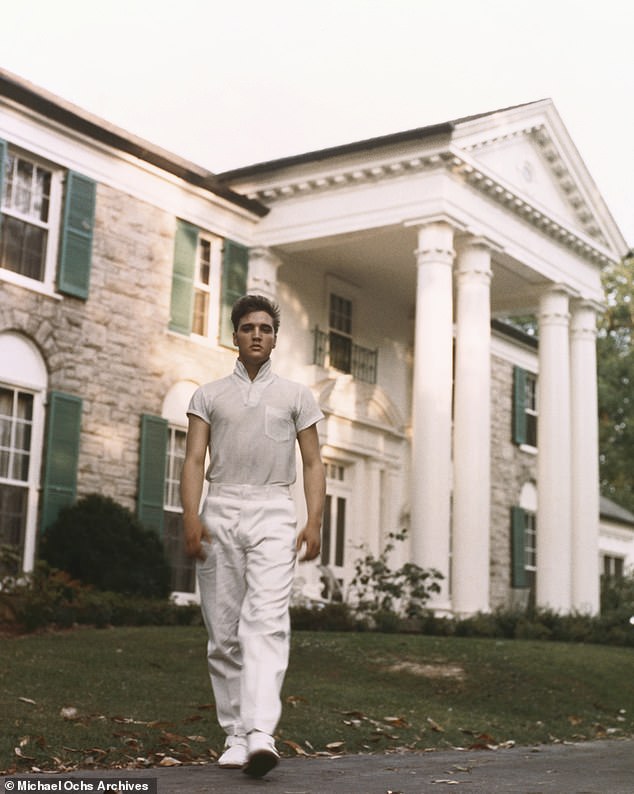 Elvis purchased the Graceland estate in 1957 for $102,500, the same year he recorded a string of iconic hits including 'Blue Christmas' and 'All Shook Up';  Elvis pictured in 1957 in Memphis