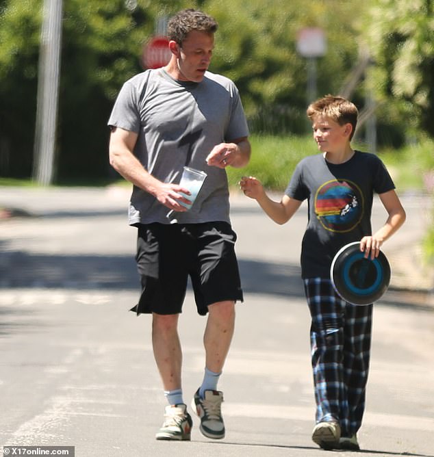 Affleck completed the look with a pair of old school white Nike sneakers with green and orange detailing