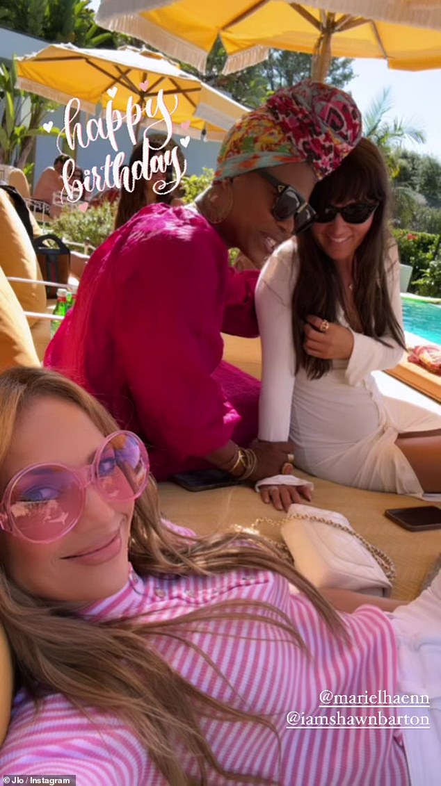While Affleck bonded with his son, Lopez took to her Instagram to wish one of her friends a happy birthday as she relaxed by the pool in a chic pink outfit.