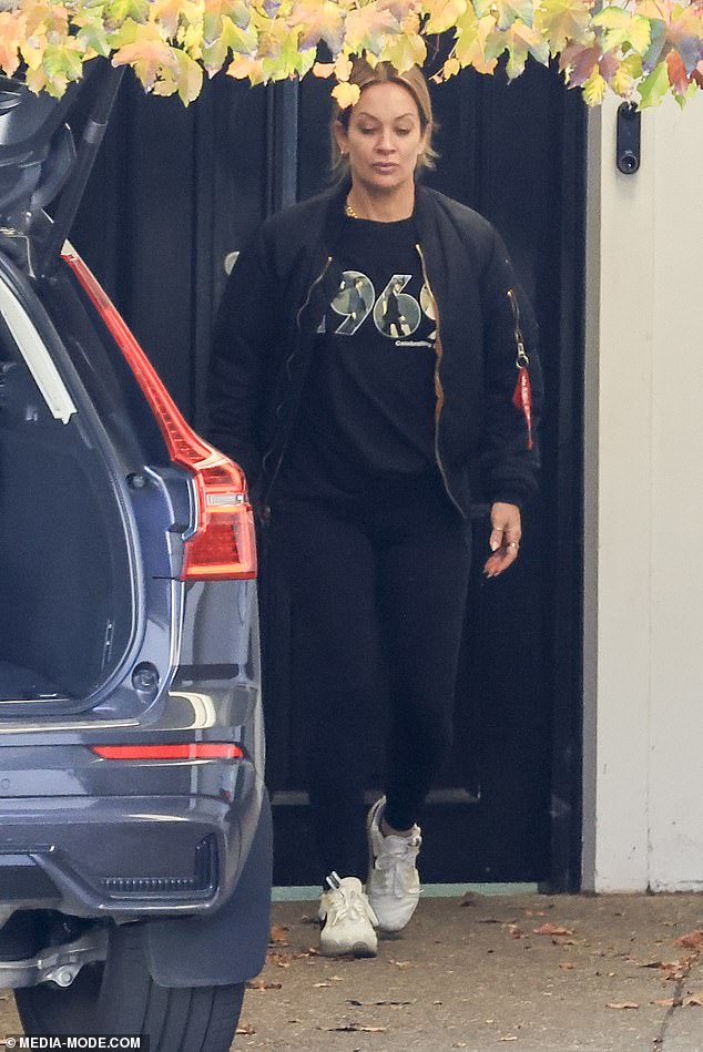 Mia wore a black bomber jacket, a '1969' t-shirt, black leggings and white sneakers