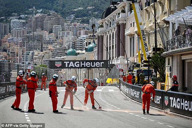 Race marshalls cleared the track after the race was red flagged following the first lap crash