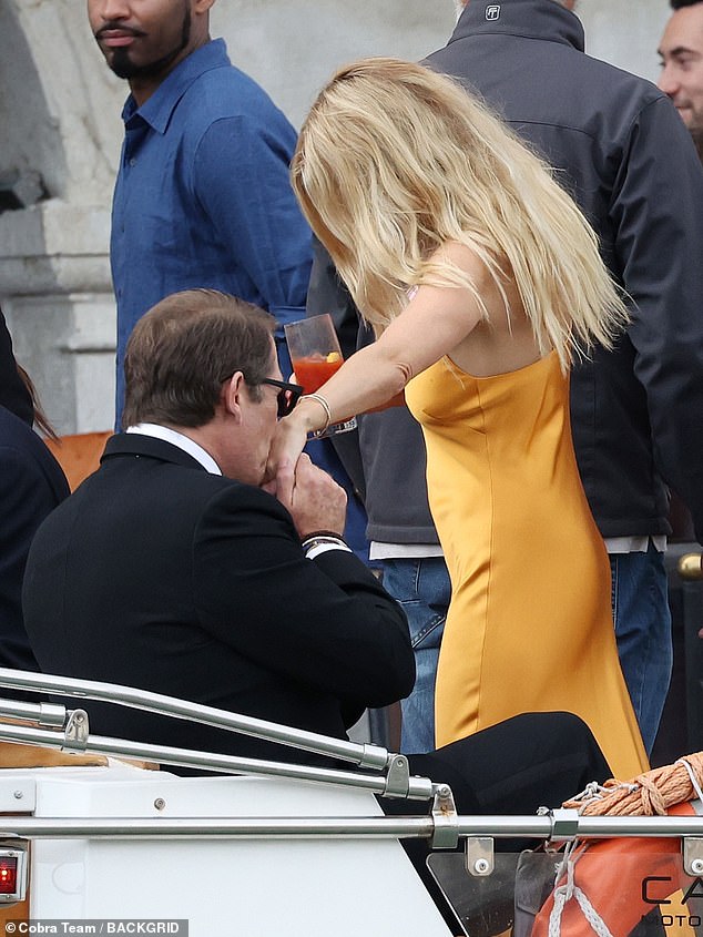 Sienna was helped into the boat by another guest, who also kissed her on the hand