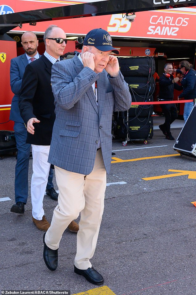 The monarch opted for cream-colored chinos and a navy blue checked jacket and baseball cap