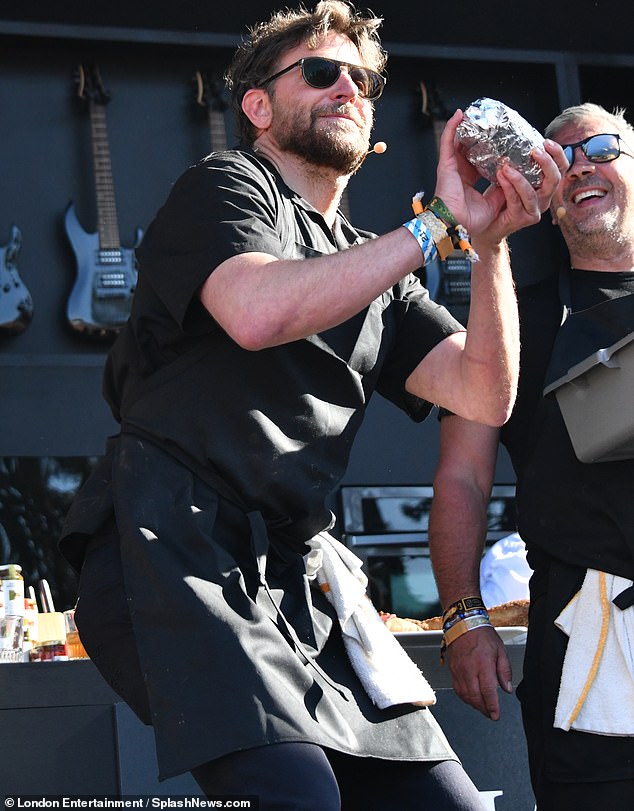 While having fun on stage with his pop-up food cart partner Danny DiGiampietro, the owner of Angelo's Pizzeria in South Philadelphia, Cooper was also seen preparing his aim to throw a sandwich into the crowd, perhaps for Hadid.