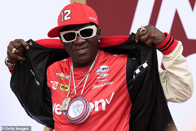 Rapper Flavor Flav was also photographed before heavy rain delayed the start of the race