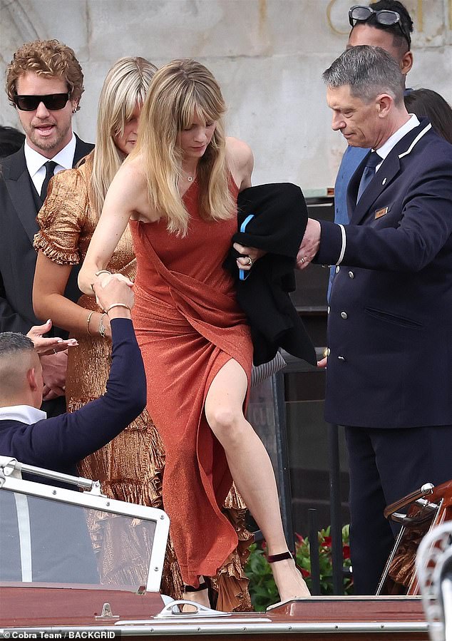 The mother-of-one wore a shimmering bronze dress with a daring thigh-high slit at the side