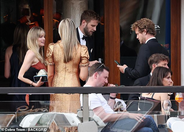 Cressida looked cheerful as she chatted with other guests at the billionaire's wedding in Venice