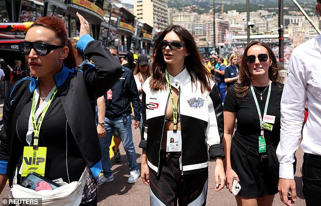 To really get into the Formula 1 spirit, she threw on a black and white leather racing jacket, but left the buttons unbuttoned to keep her cleavage visible.