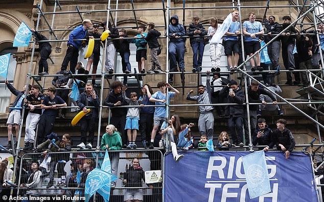 City fans climbed scaffolding throughout the city to get a good vantage point for the parade