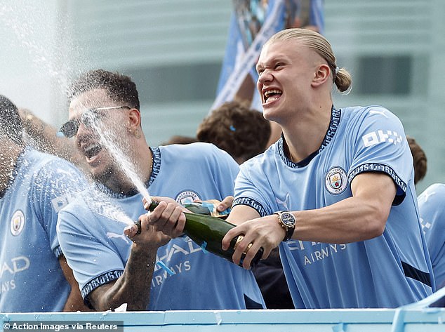 Some fans were drenched by Haaland and Ederson, who sprayed champagne from the bus