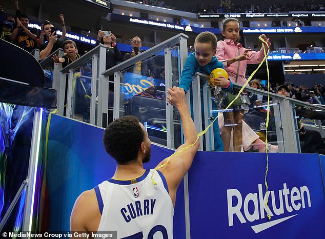 Curry is congratulated by his son Canon as his daughter Riley looks on after a victory in January