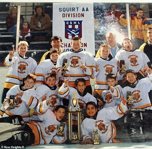 A young Kelce (pictured center of photo) is seen holding a trophy during his pee hockey days