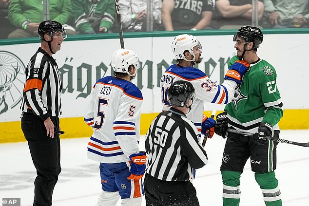 Oilers center Sam Carrick talks to Dallas Stars left wing Mason Marchment (27) in the third