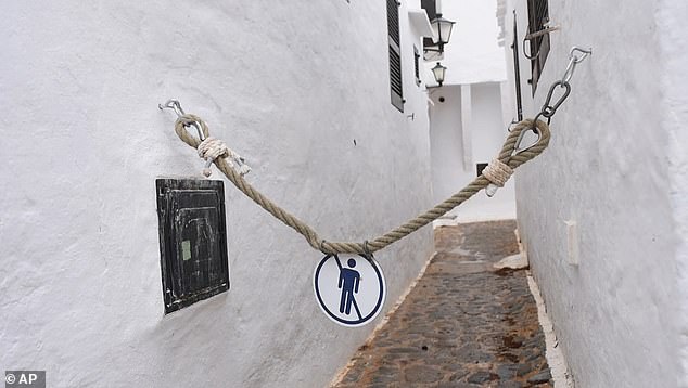 Angry locals have attached no-go signs to ropes and chains around the town to deter visitors