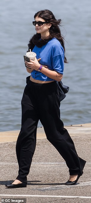 Kaia's short-sleeved button-down top was paired with black lounge pants and a pair of black leather ballet flats