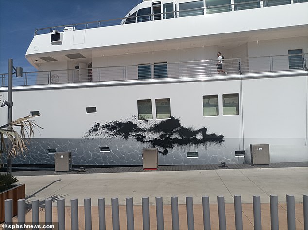 Protesters splashed black paint over the superyacht