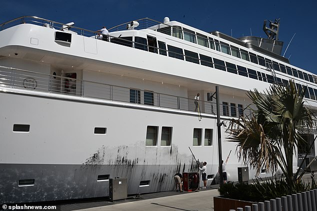 Workers immediately began scrubbing the yacht's paint