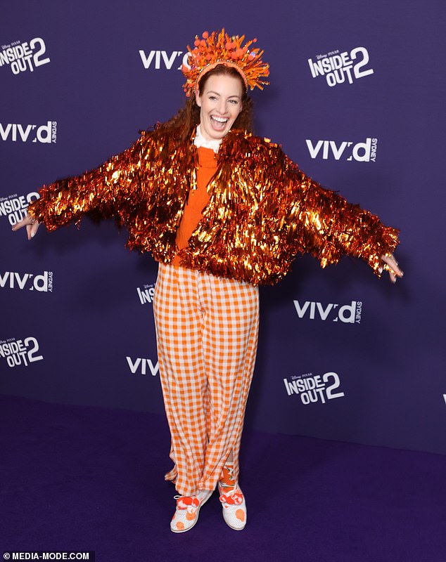 Also turning heads was Emma Watkins (pictured), who was unmissable in a bright orange ensemble with a tinsel jacket and crown