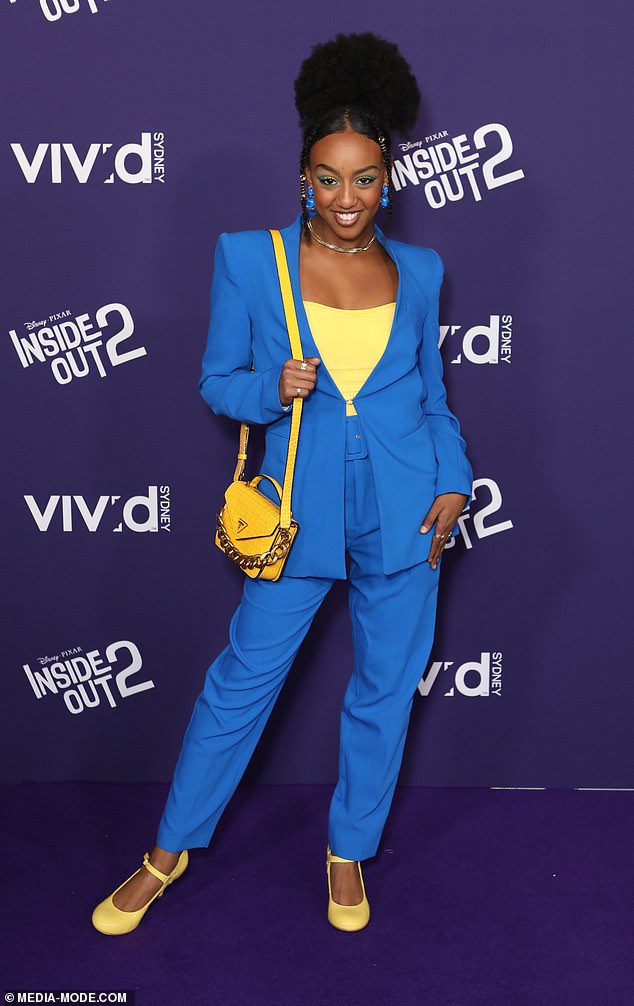 Wiggles star Tsehay Hawkins (pictured) opted for a bright blue suit paired with bold yellow accents, including a sunny-hued blouse, bag and heels