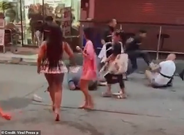 The man in white was pushed to the ground, where bouncers started pounding on him