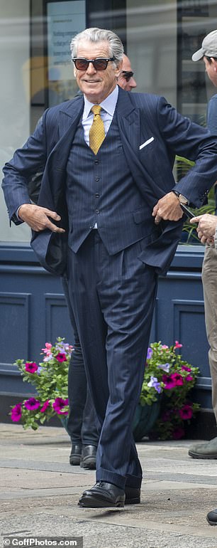 The Irish actor cut a typically suave figure in a navy blue suit and matching vest