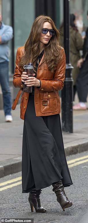 Cate looked chic as she wore a brown leather jacket with a black maxi dress underneath