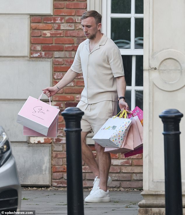 The Love Island winner, 27, and the West Ham United footballer, 27, (pictured) were doting parents through and through as they carried presents, bags and decorations from the car park