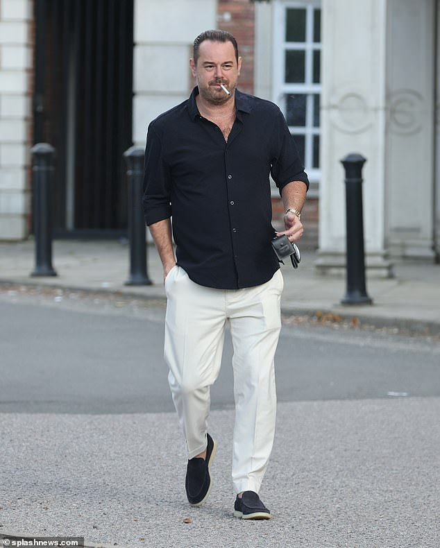 Ex-EastEnders star Danny smoked a cigarette as he walked into the restaurant wearing a black shirt and smart cream trousers