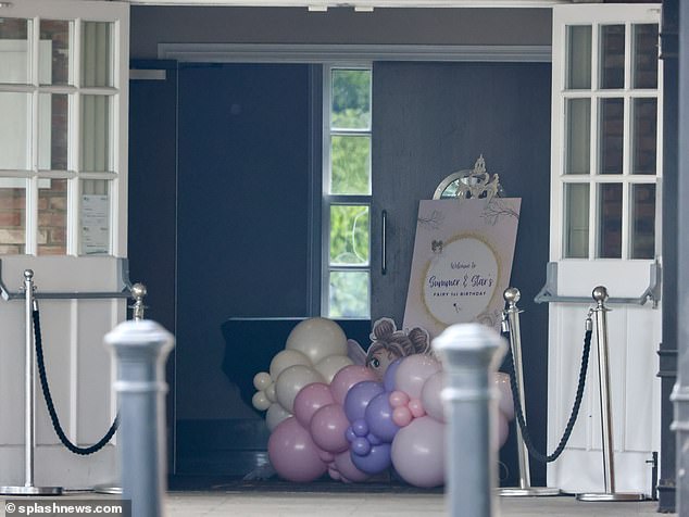 The entrance to the restaurant was decorated with numerous white, pink and lilac balloons with a sign that read: 'Welcome to the first birthday of the fairy of Summer and Star'.