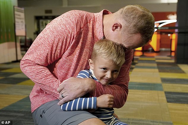 Hagerich – seen here Friday with his son – was the only one to get such a deal from a judge after pleading guilty to firearms possession