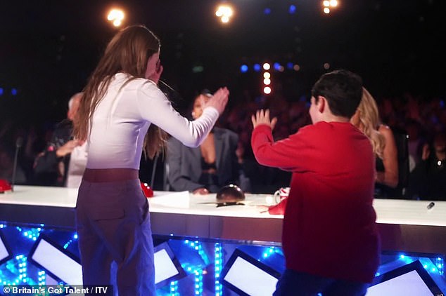 Simon said he had 'never heard a reaction like that' before gesturing to his son Eric, 10, to press the button after Japanese show jumping dancers Haribow auditioned