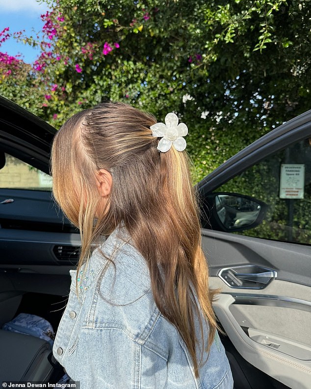 Her daughter wore a white flower hair clip and a denim jacket