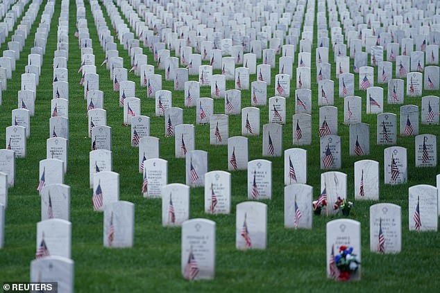 Tombstones decorated with American flags are seen at Arlington National Cemetery on Memorial Day in Arlington, Virginia, USA, May 27, 2024