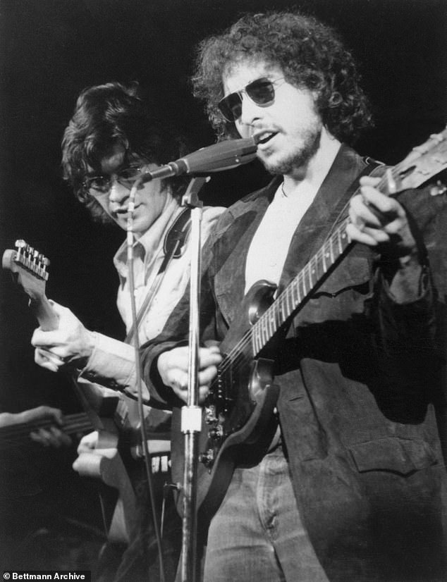 Robbie, a five-time Grammy nominee who was inducted into the Rock & Roll Hall of Fame, is seen here shredding with Dylan in 1972, before becoming a founding member of The Band.